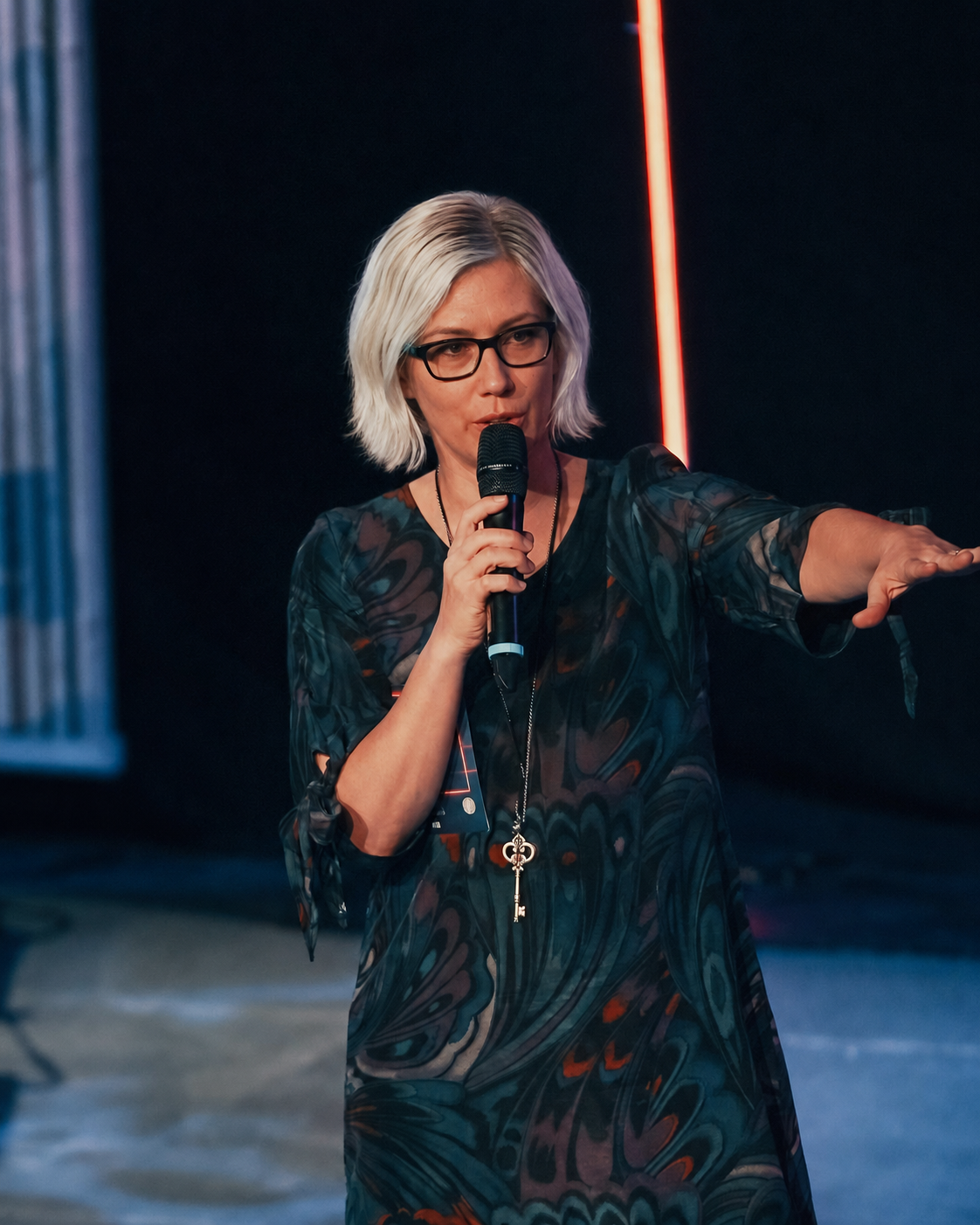 Ruth Truttmann speaking with a microphone at an event